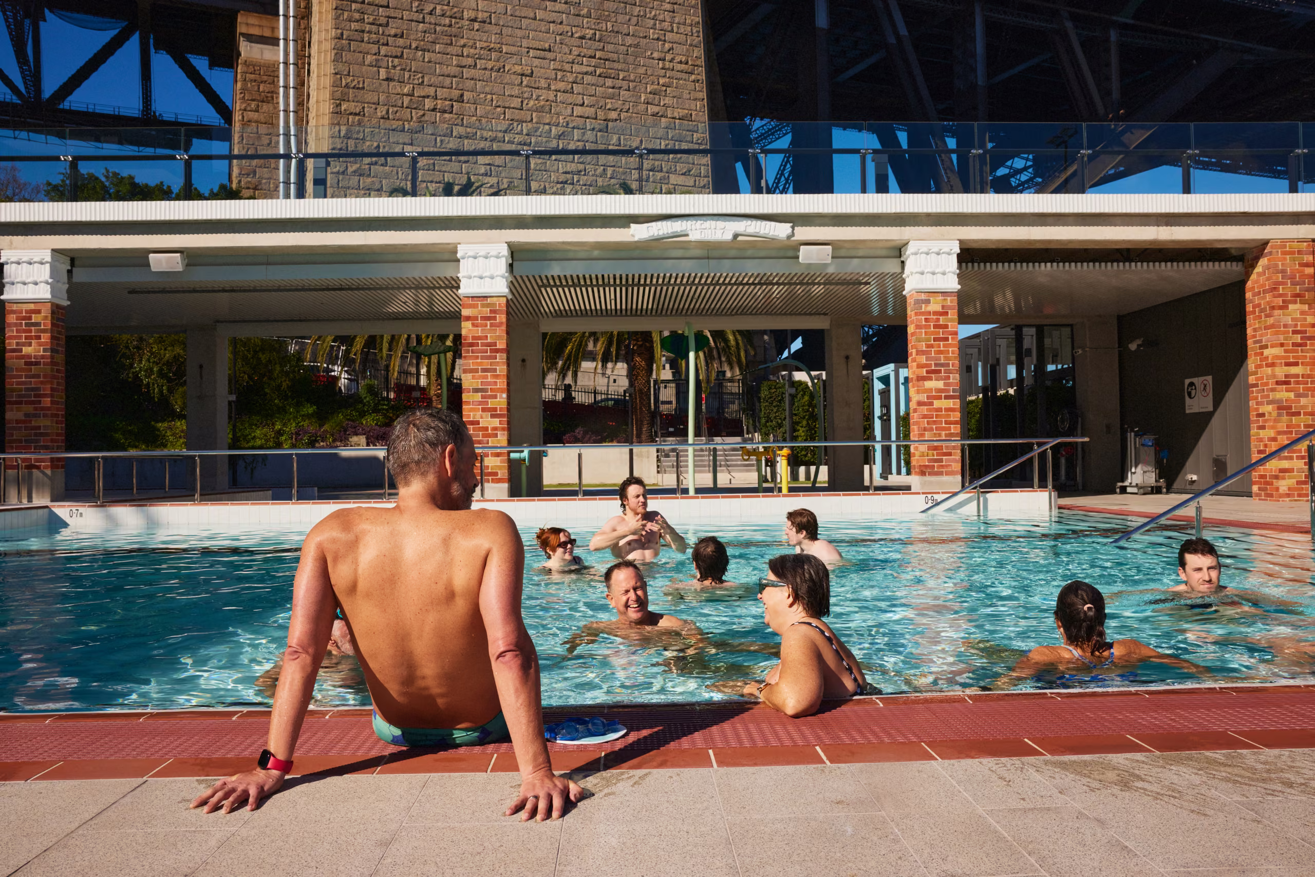 Families in the water at the pool on a summer afternoon