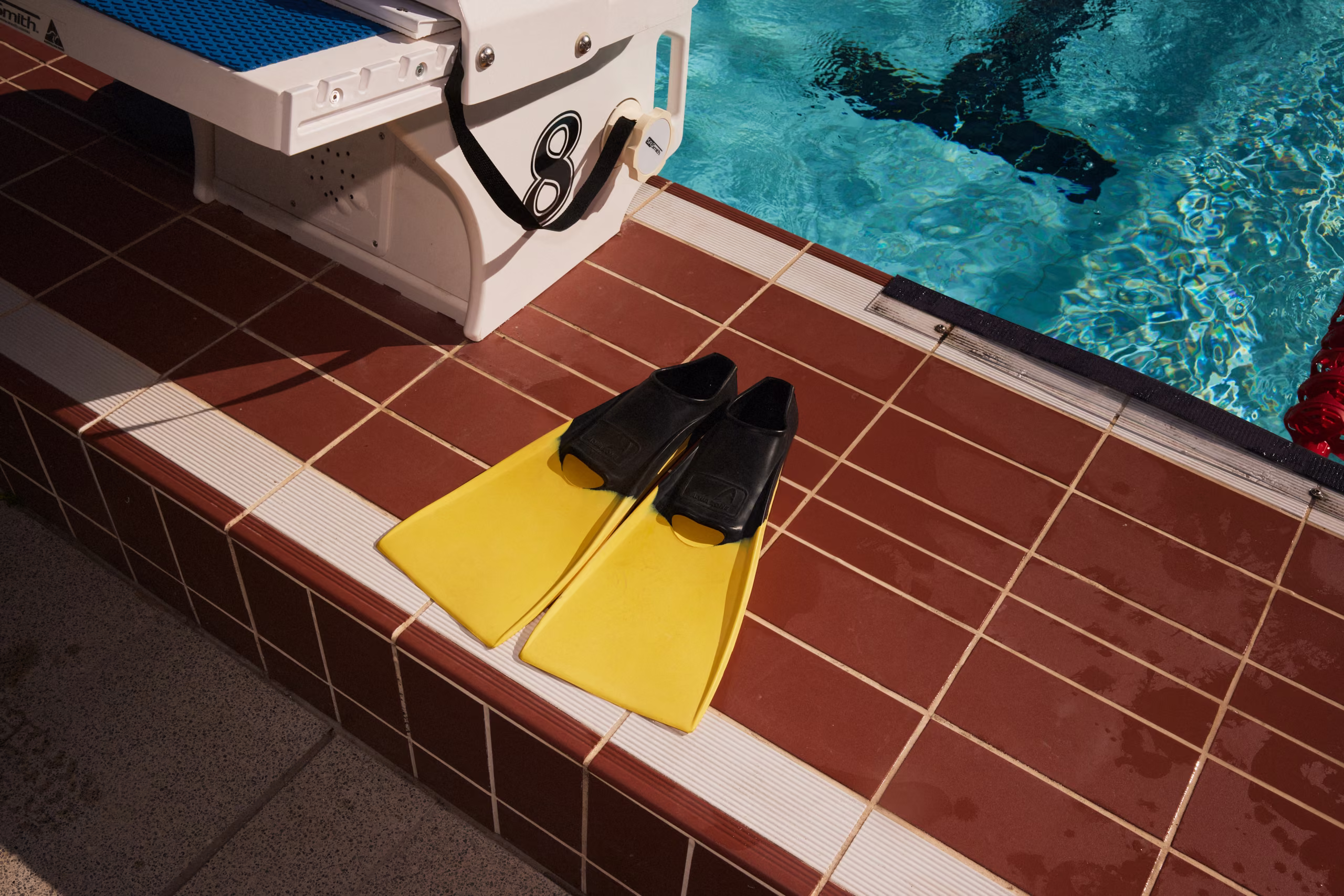 Fins resting on the tiled pool deck