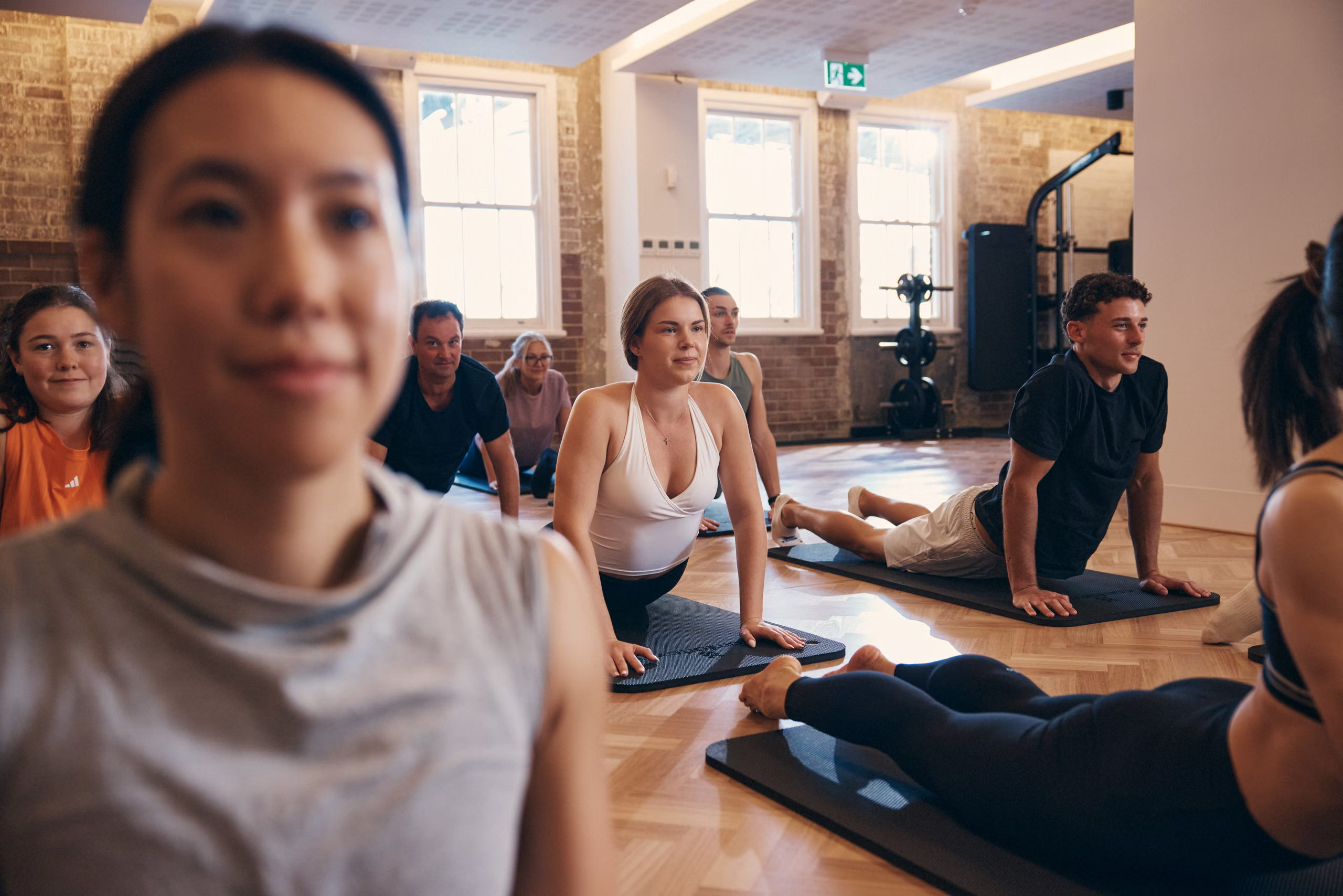 A mat class stretching in the group fitness studio