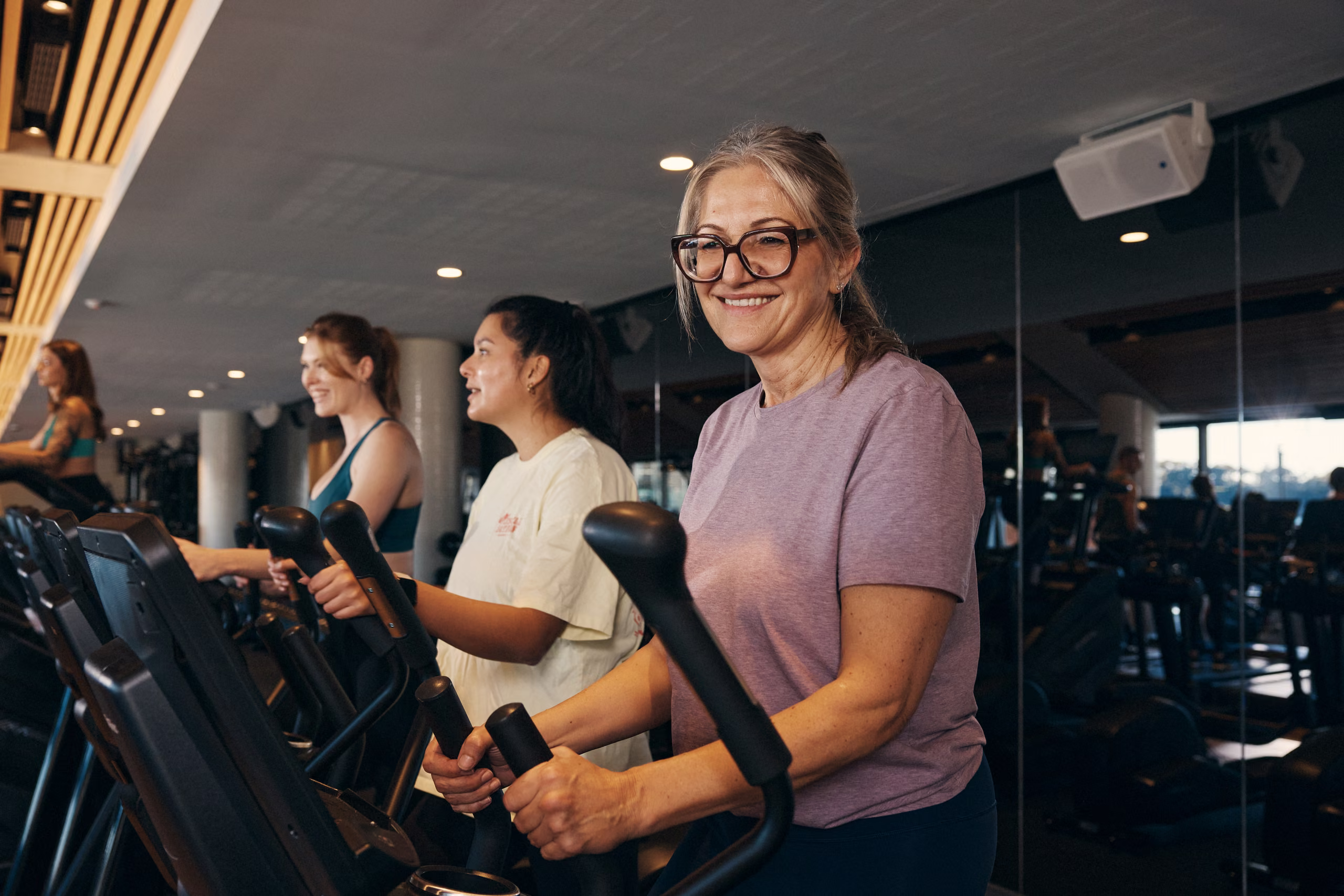 A member on a cardio machine on the gym floor